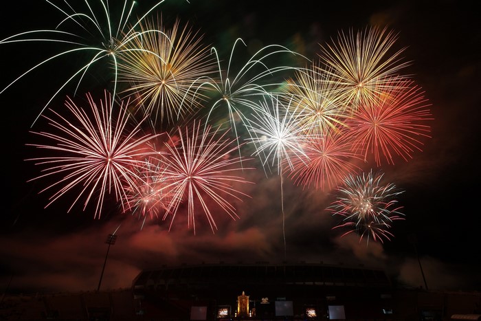 Fireworks display over a stadium at night