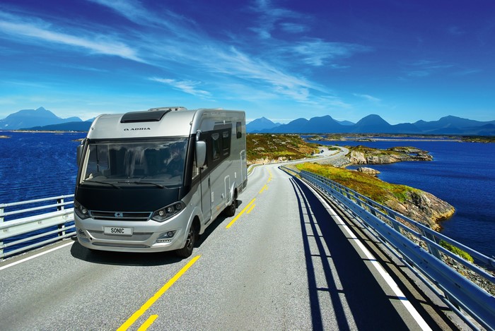 Adria Sonic motorhome driving on a scenic coastal road