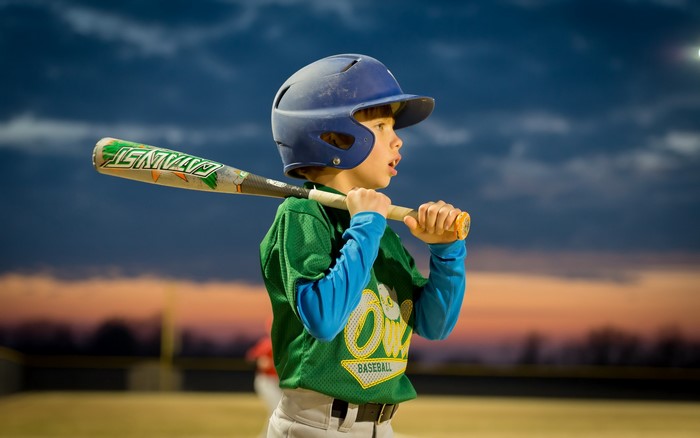 Boy in baseball uniform holding a bat