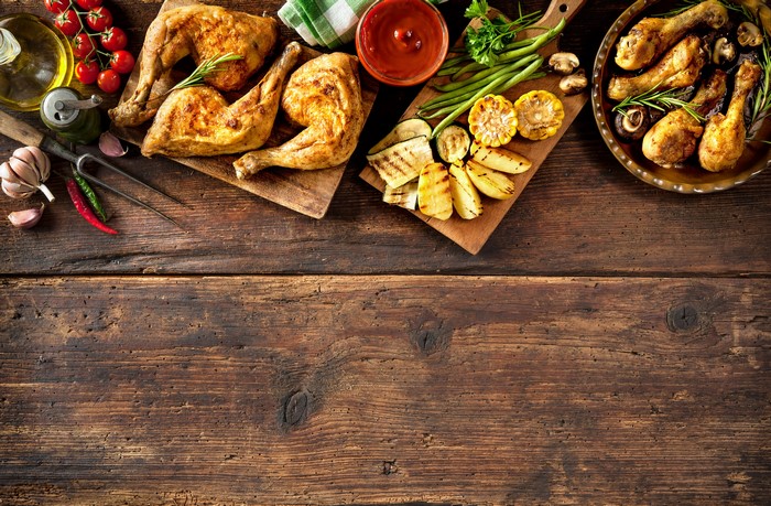 Roast Chicken and Grilled Vegetables on Wooden Table