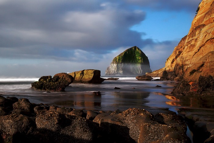 Haystack Rock and coastal cliffs at sunset