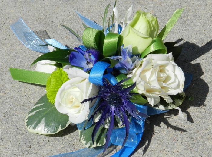 Corsage with white roses and blue flowers