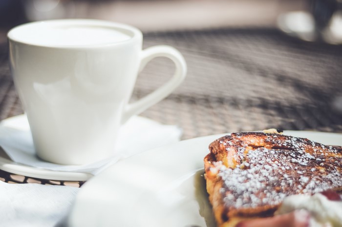 White cup of coffee and pastry on a table