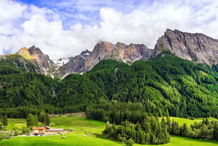 Mountain range with forests and houses in Italy