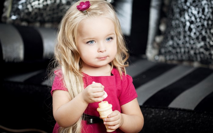 Little blonde girl with a flower in her hair