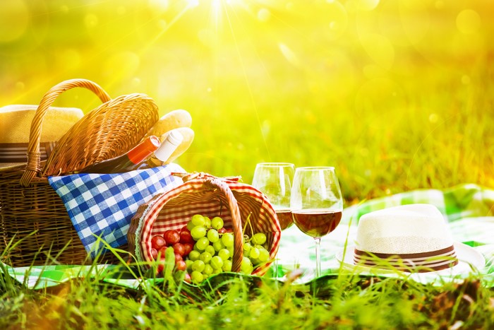 Picnic with wine, grapes, and hat