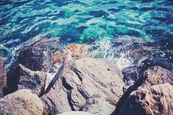 Waves crashing on rocks by the sea