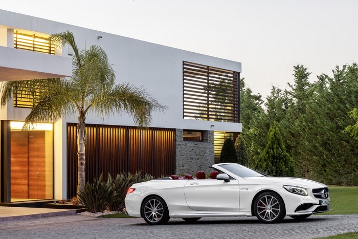 White Mercedes-Benz S-Class Cabriolet parked by a modern house