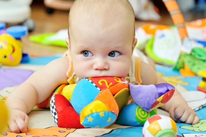 Baby playing with colorful toys