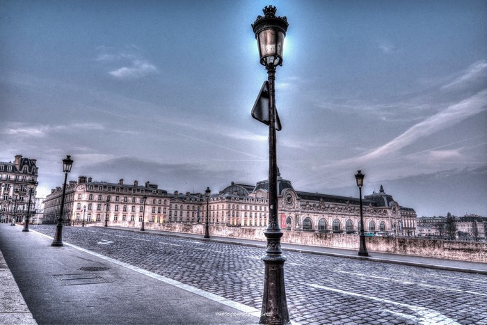 Street lights on a cobblestone road in Paris, France