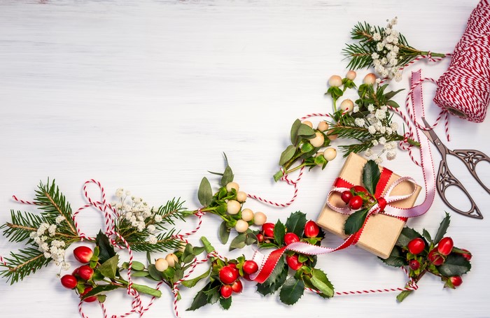 Christmas gift wrapping with branches and berries