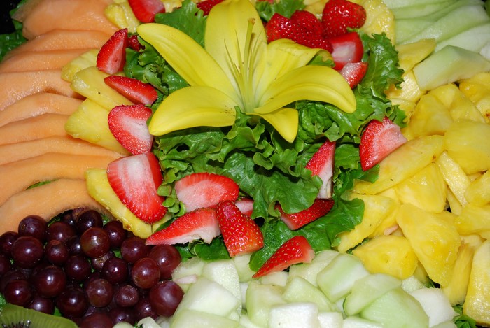 Fruit platter with strawberries, grapes, melon, and pineapple