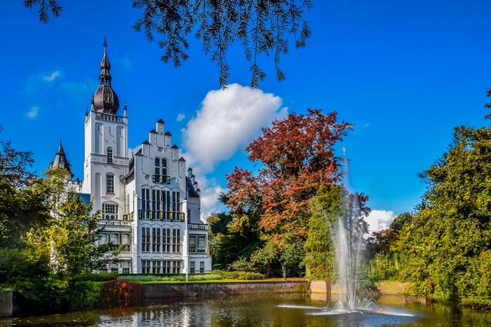 Leeuwenstein Castle with fountain and trees in Netherlands