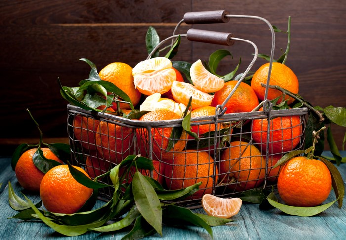 Basket of tangerines with leaves