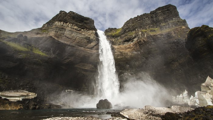 Waterfall cascading down a rocky cliff in Iceland