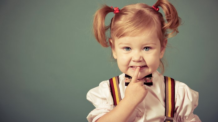 Little girl with pigtails and suspenders
