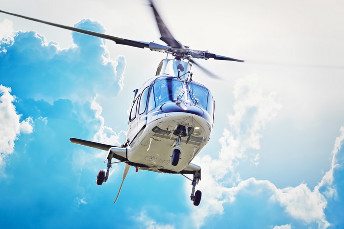 Helicopter flying in the sky with clouds
