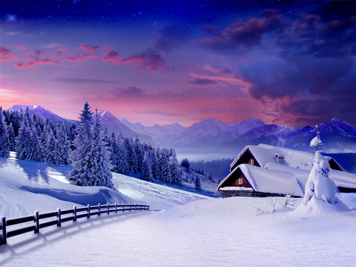 Winter mountain landscape with snow-covered cabins and fence
