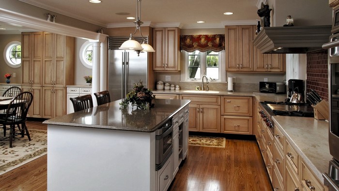 Kitchen with island, dining table, and cabinets