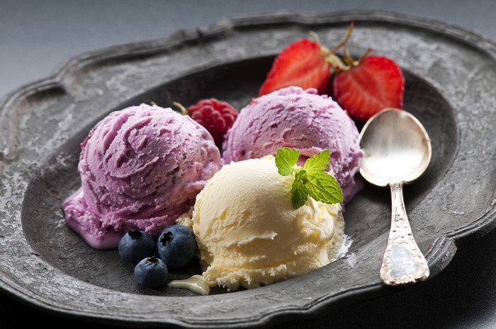 Ice cream scoops with berries on a plate