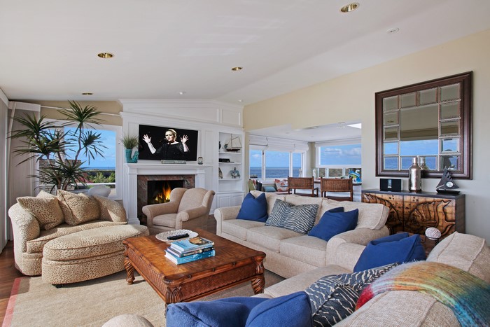 Living room with sofas, armchairs, coffee table, and fireplace
