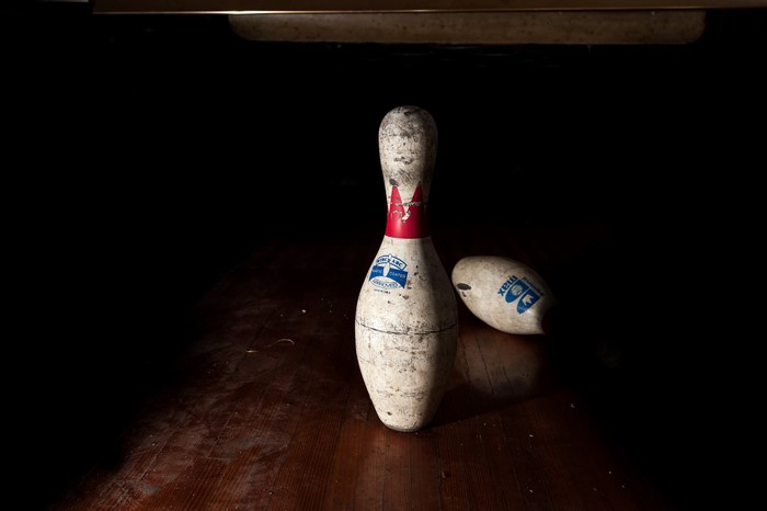 Bowling pin and ball on wooden floor