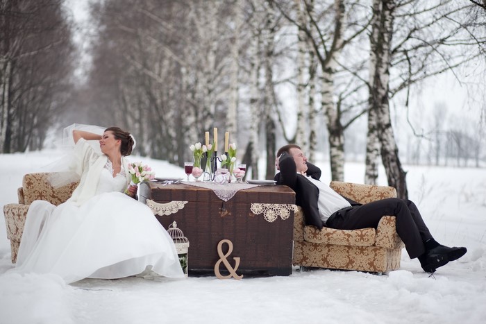 Bride and Groom sitting on armchairs in the snow