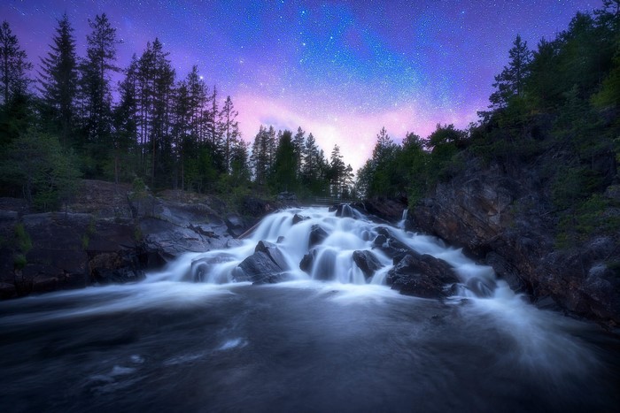 Waterfall under a starry sky in Ringerike, Norway