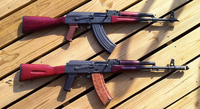 Two AK-47 assault rifles on wood planks
