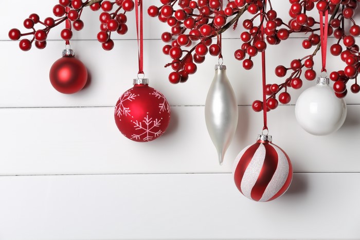 Christmas Ornaments and Berries on White Wood