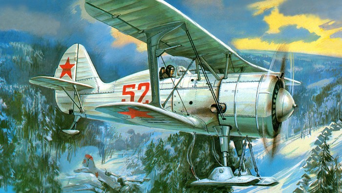 Polikarpov I-15 bis biplane flying over a snowy forest