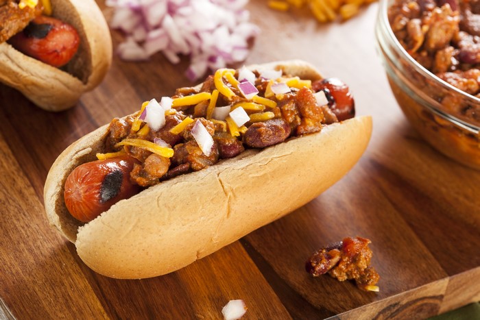 Hot dog with chili, cheese, and onions