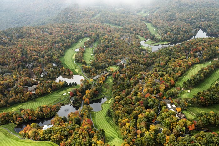 Aerial view of a golf course in autumn forests