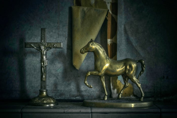 Crucifix and brass horse figurine