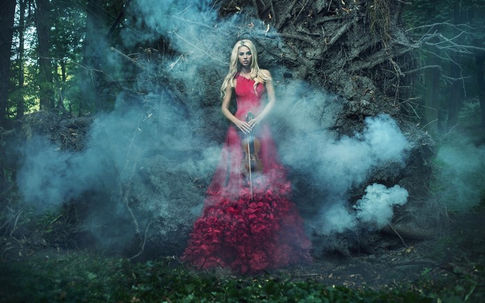 Blonde girl with violin in smoke