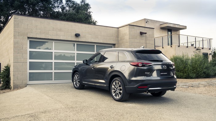 2015 Mazda CX-9 parked in front of a modern garage