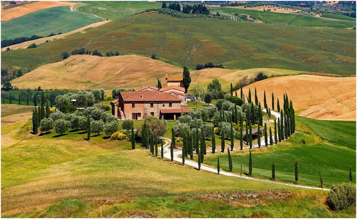 Tuscan Villa surrounded by rolling hills and cypress trees