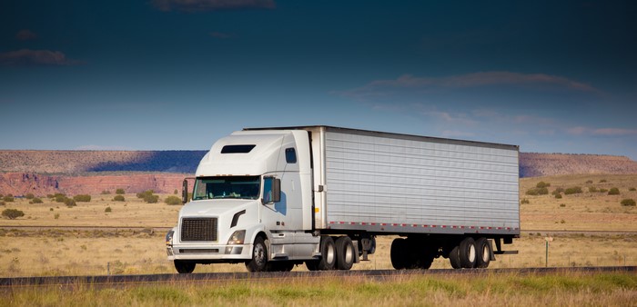 White Semi-Truck Driving on a Highway
