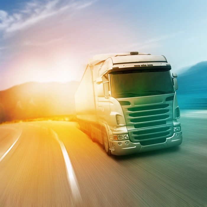 Truck driving on a road with motion blur