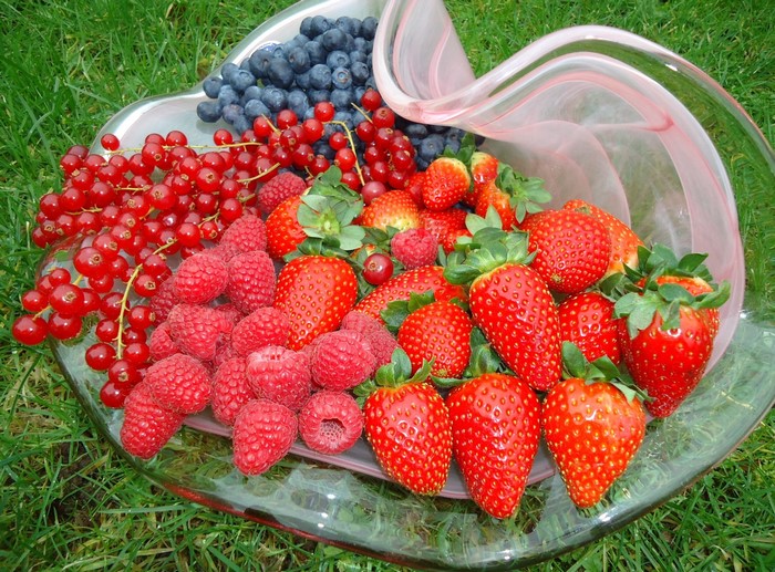 Assortment of fresh berries in a glass bowl