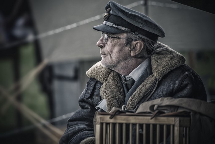 Elderly man in pilot hat and jacket