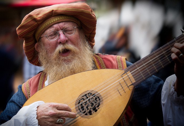 Man with beard playing a lute