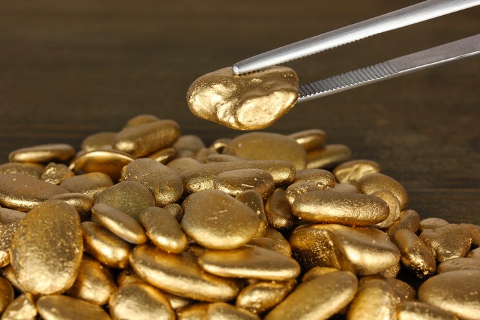 Gold nuggets with tweezers