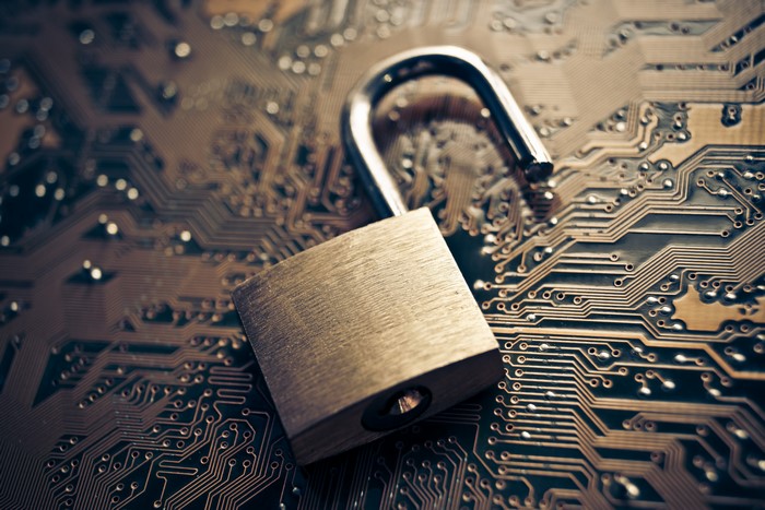 Unlocked padlock on a computer circuit board