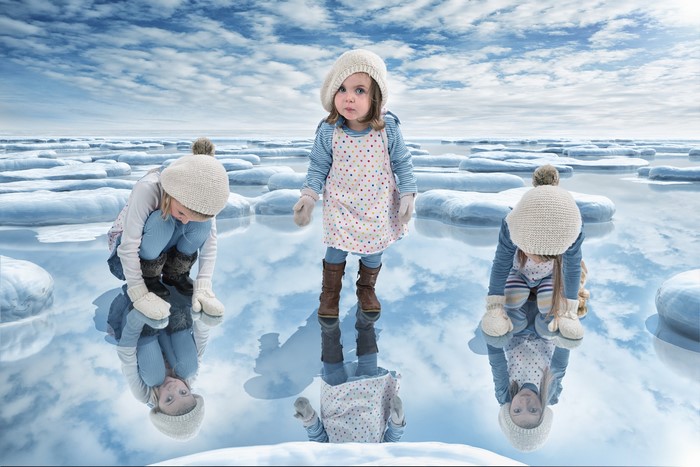 Three girls on a frozen lake with ice floes