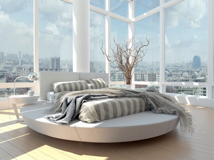 Modern bedroom with round bed and city view