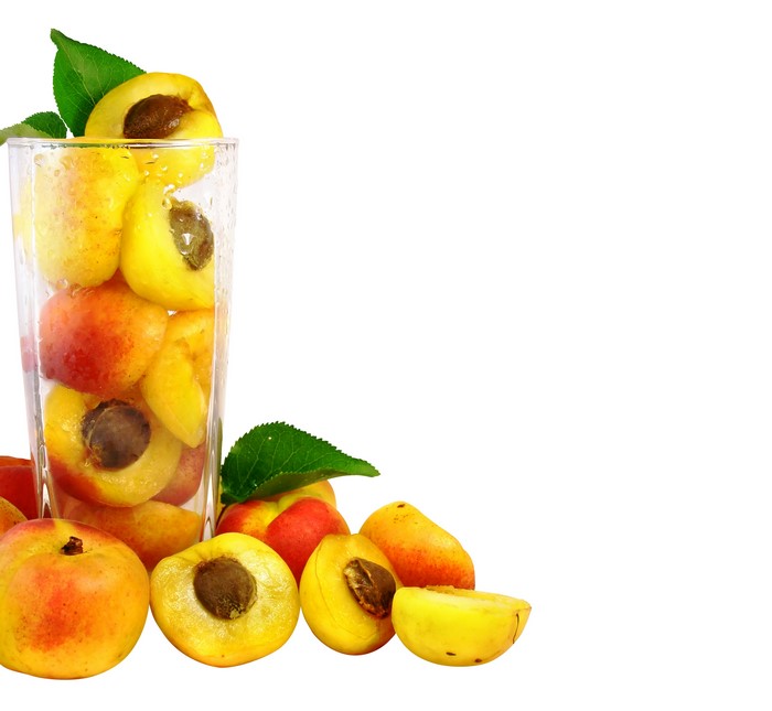 Apricots in a highball glass with leaves