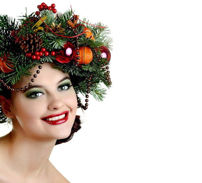 Woman with Christmas wreath on head and festive makeup