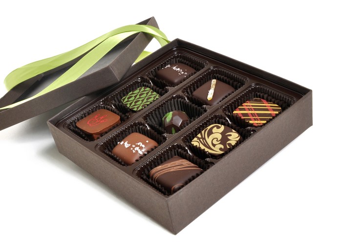 Box of assorted chocolates with green ribbon
