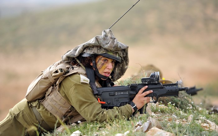 Soldier with rifle in camouflage